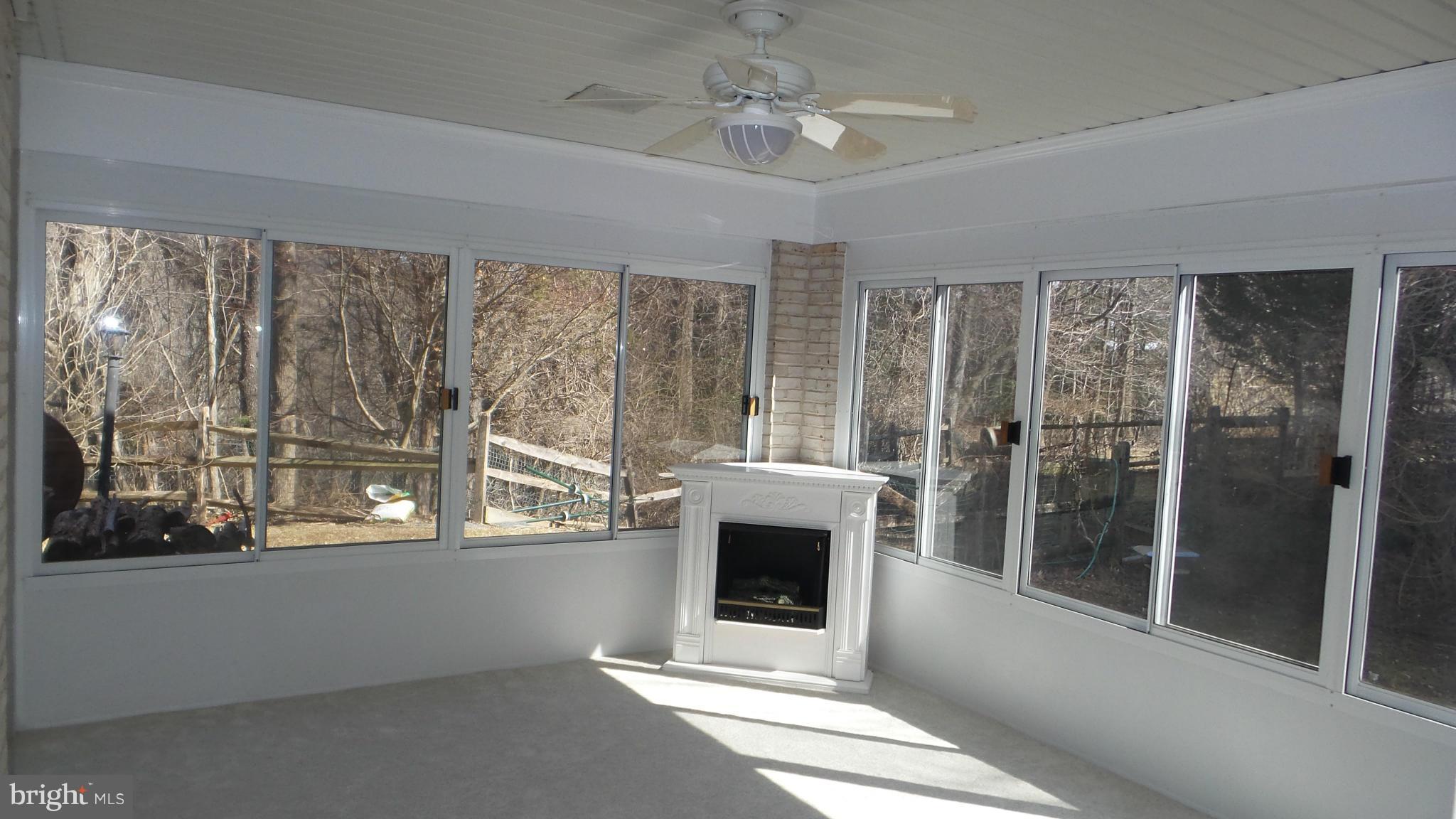 13409 Bladon Road Phoenix, MD 21131 - Photo 20 of 27 a view of an empty room with a fireplace and a window