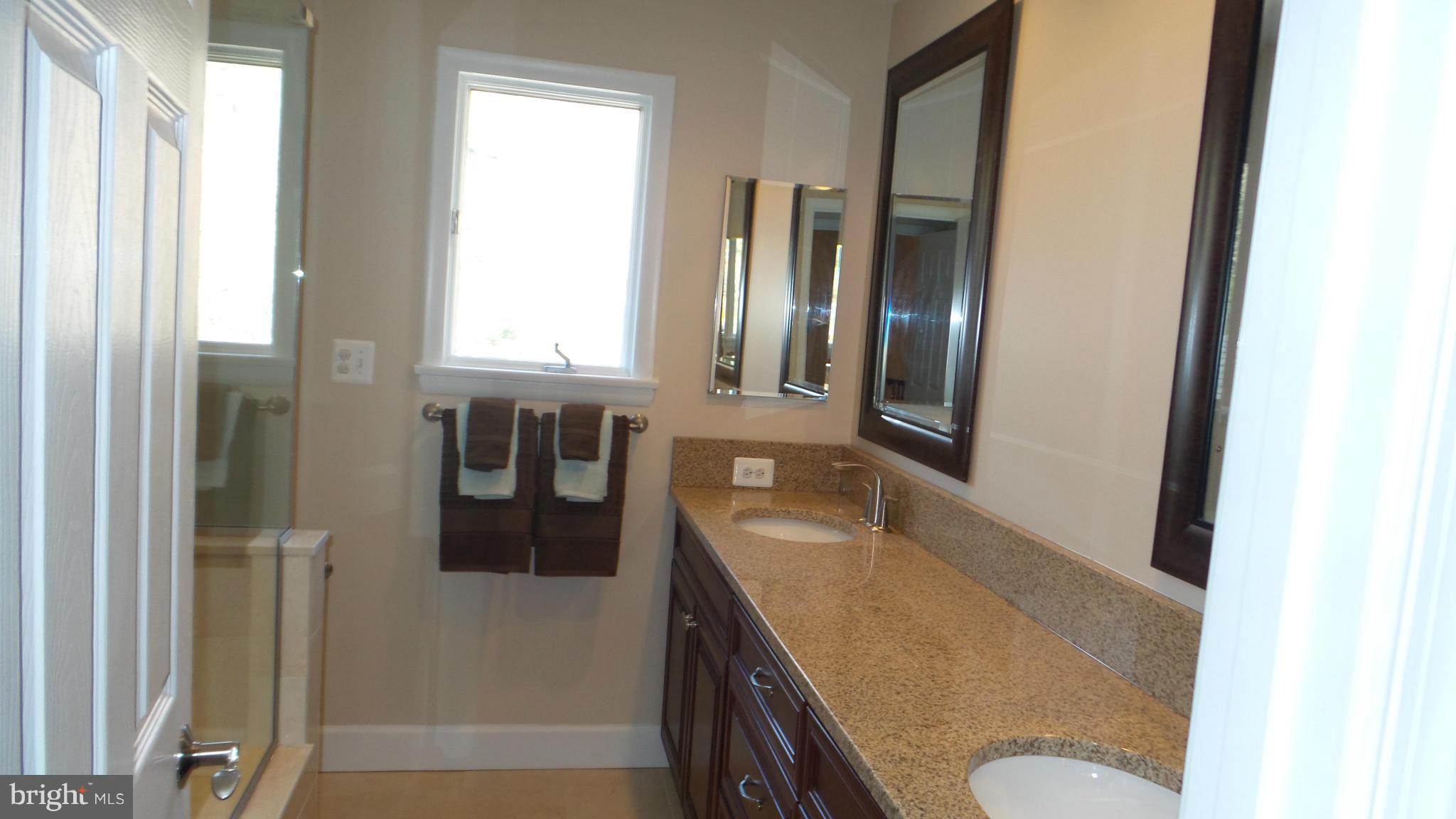 13409 Bladon Road Phoenix, MD 21131 - Photo 9 of 27 a bathroom with a granite countertop sink and a mirror