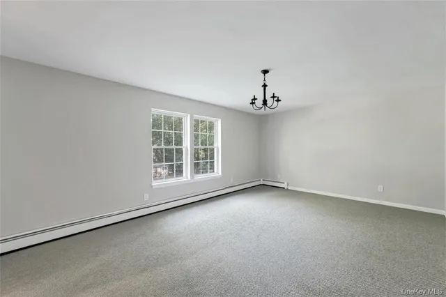 an empty room with a empty space and windows
