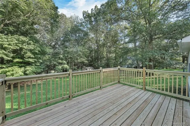 a view of balcony with wooden floor and fence