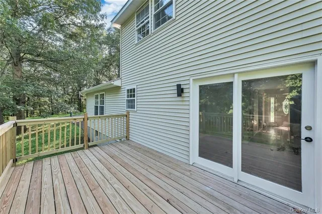 a view of backyard with a deck