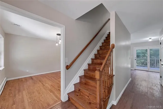 a view of entryway with wooden floor and stairs