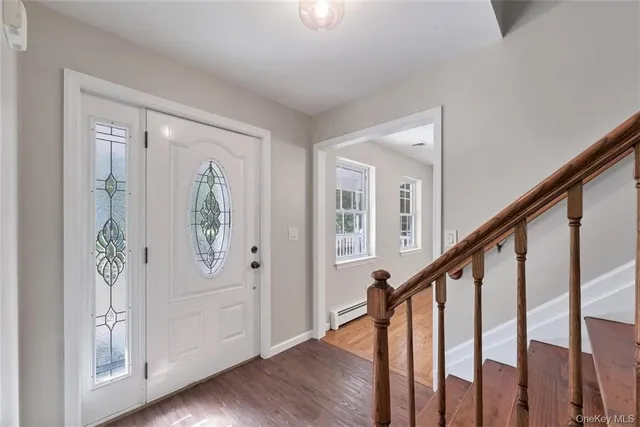 a view of an entryway with wooden floor