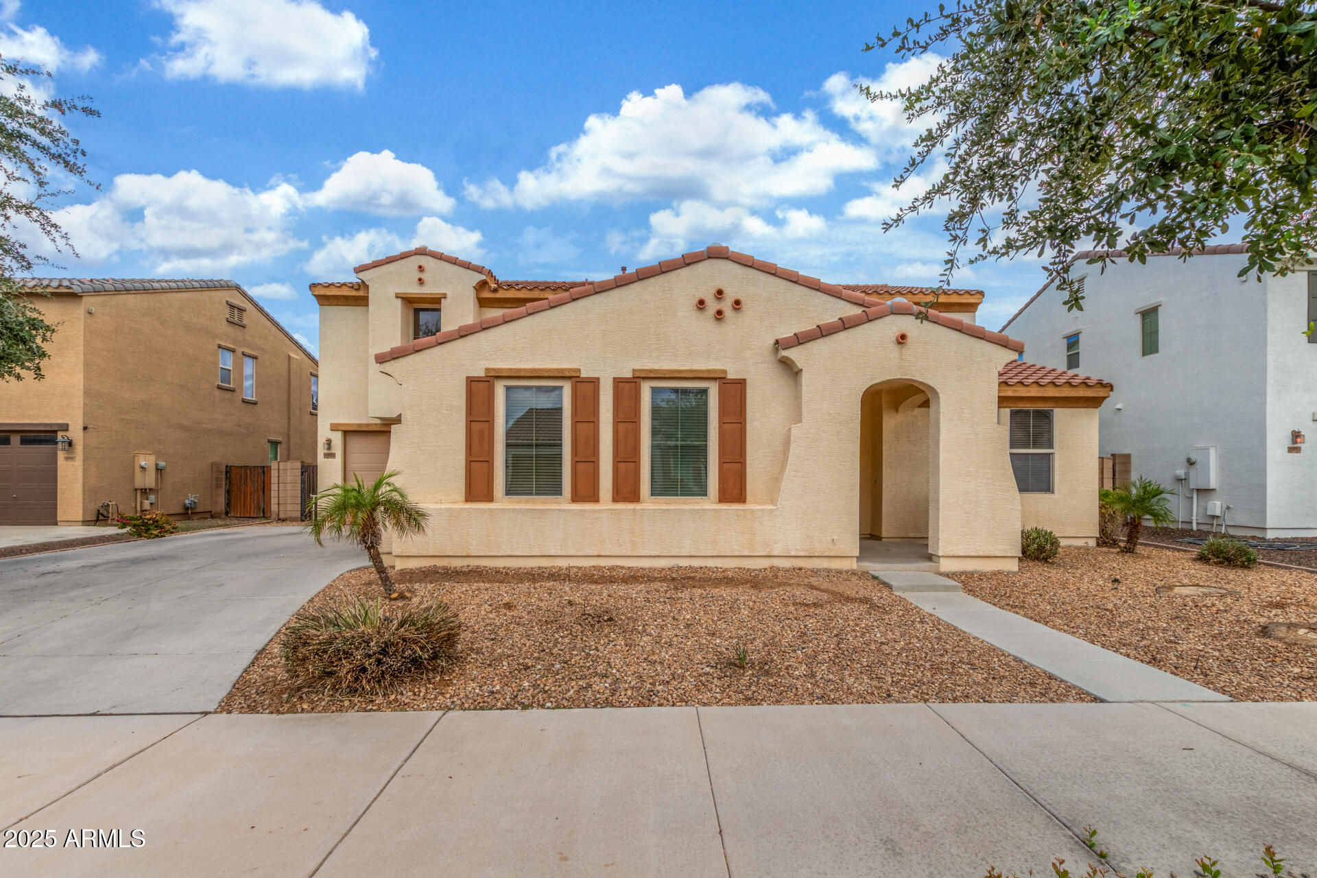 20932 Vía De Arboles Queen Creek, AZ 85142 - Photo 1 of 58 a front view of a house with a yard and garage