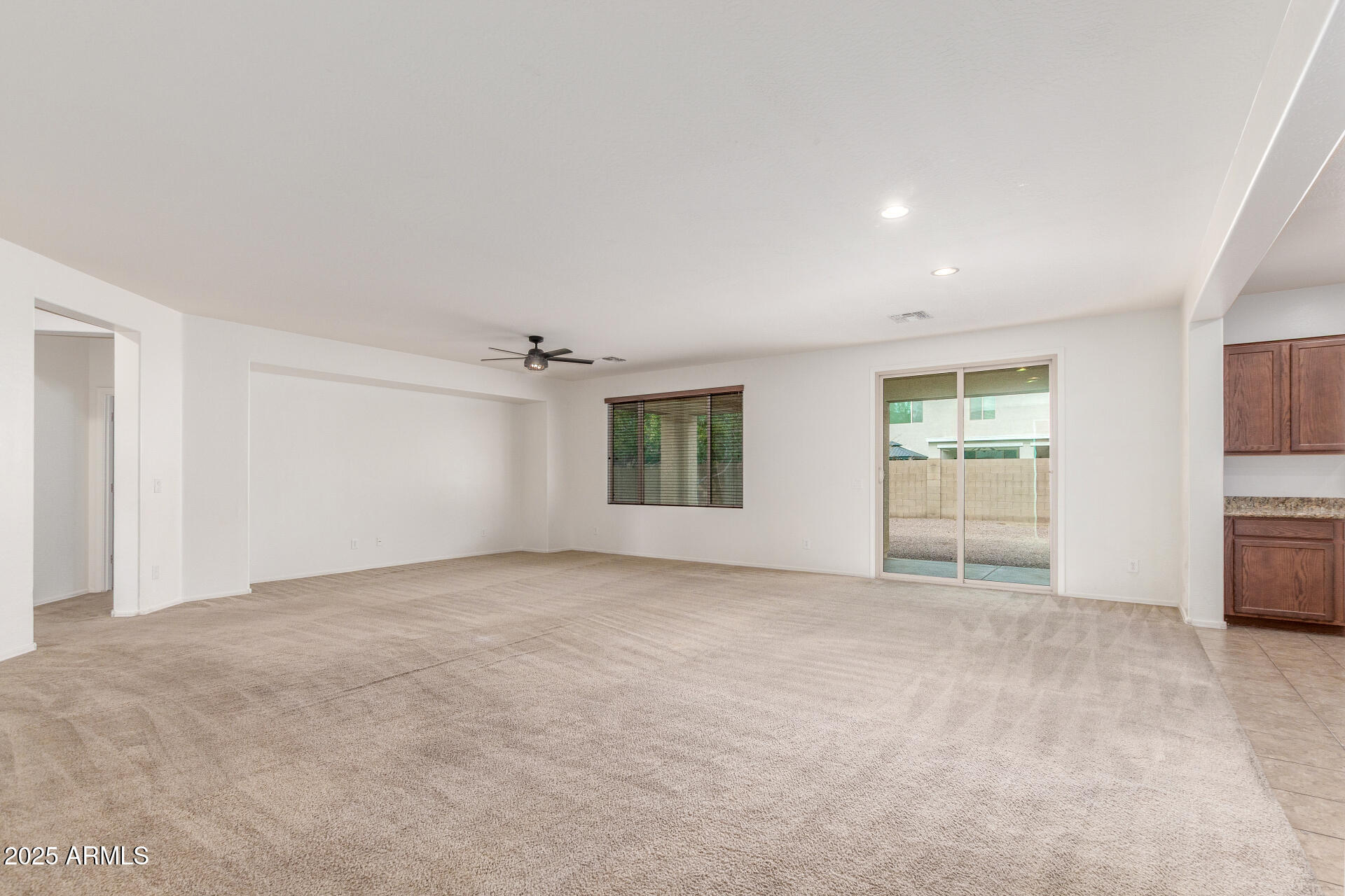20932 Vía De Arboles Queen Creek, AZ 85142 - Photo 14 of 58 an empty room with windows and cabinet