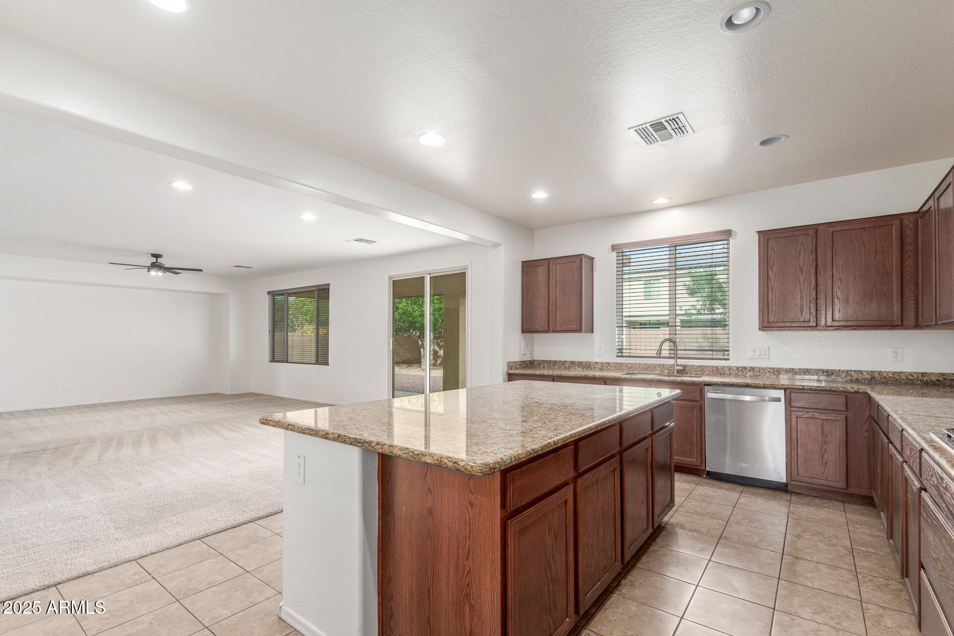 20932 Vía De Arboles Queen Creek, AZ 85142 - Photo 16 of 58 a large kitchen with kitchen island a sink granite counter tops and a stove