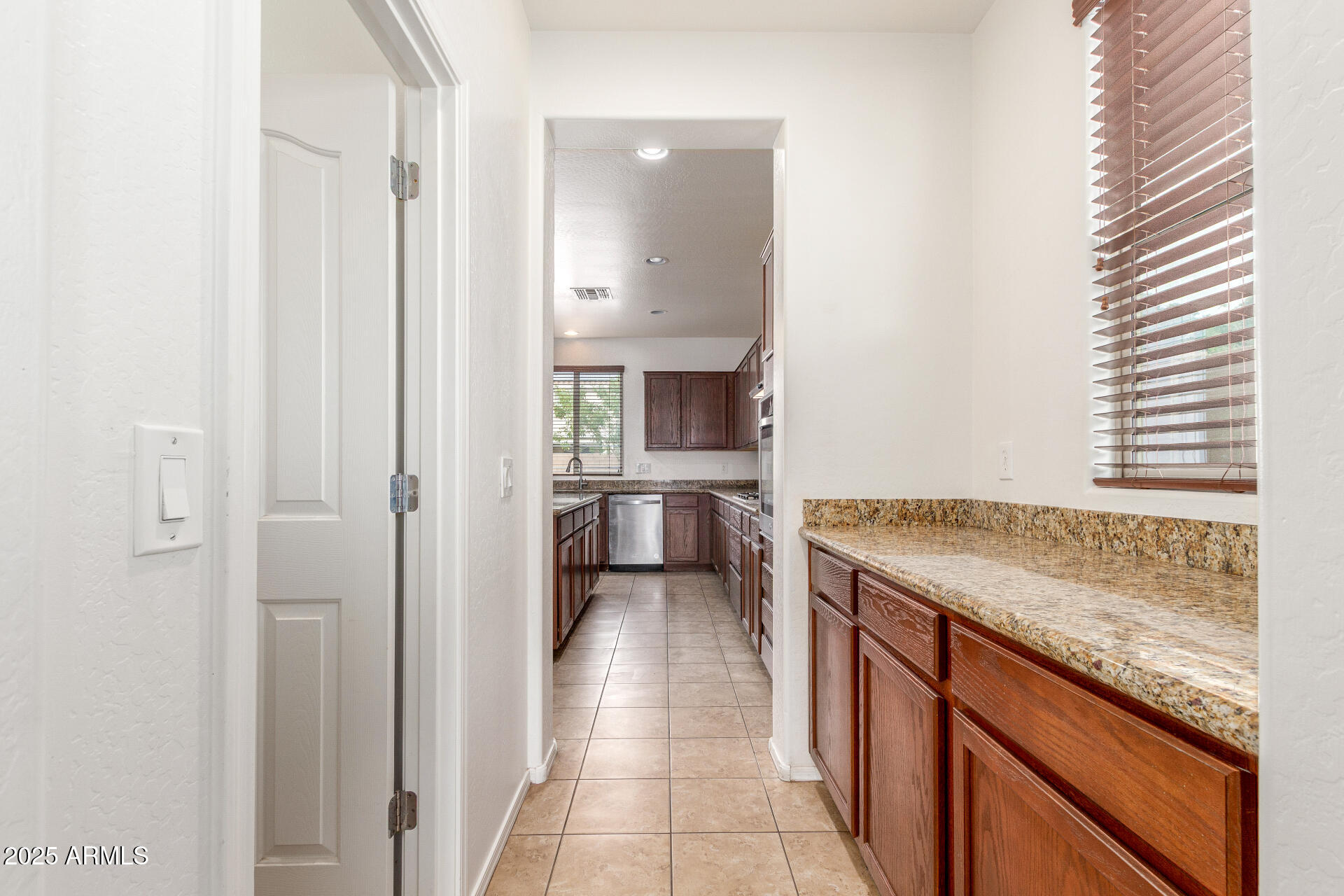 20932 Vía De Arboles Queen Creek, AZ 85142 - Photo 22 of 58 a kitchen with a sink stove and cabinets