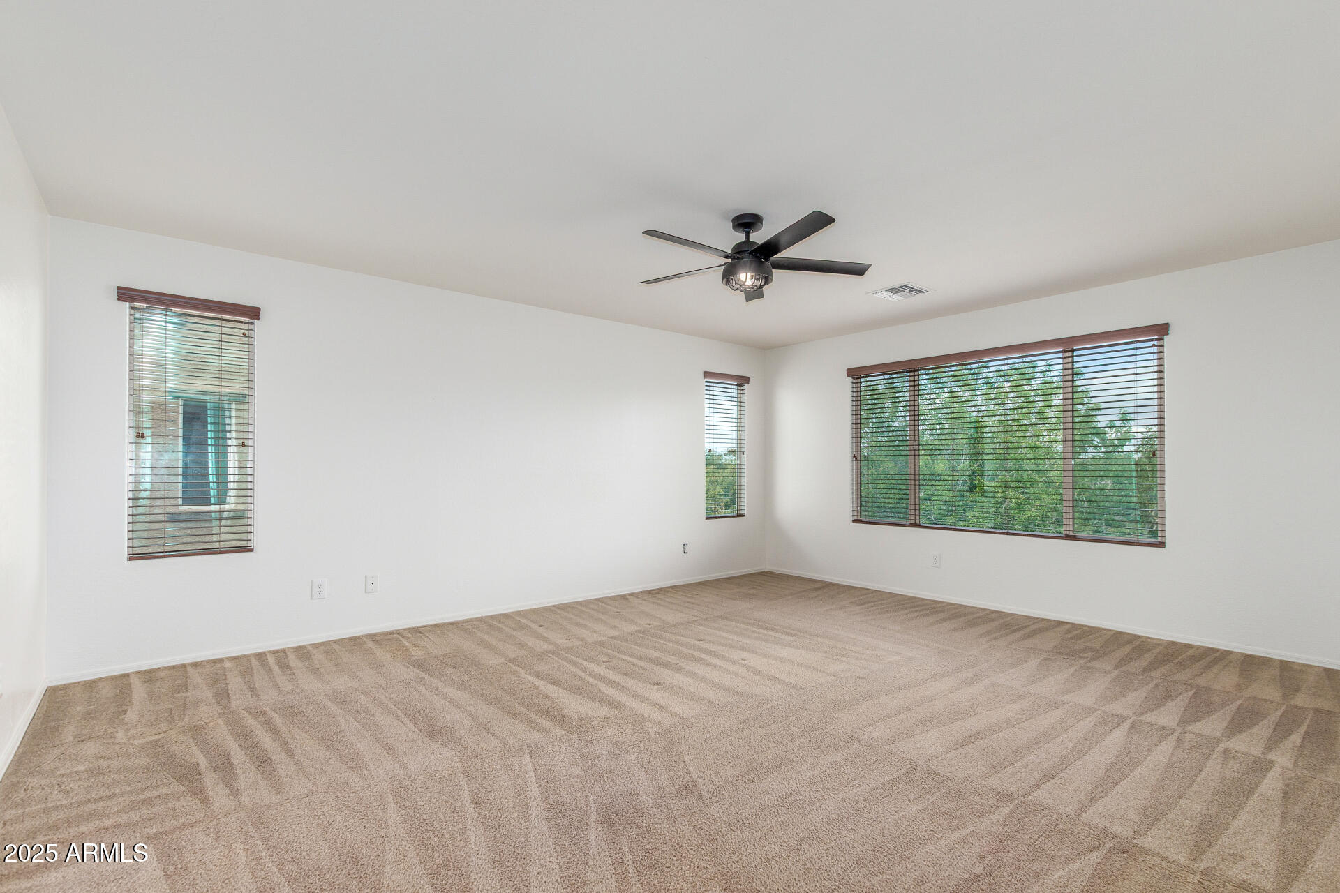 20932 Vía De Arboles Queen Creek, AZ 85142 - Photo 24 of 58 a view of a livingroom with a ceiling fan and window