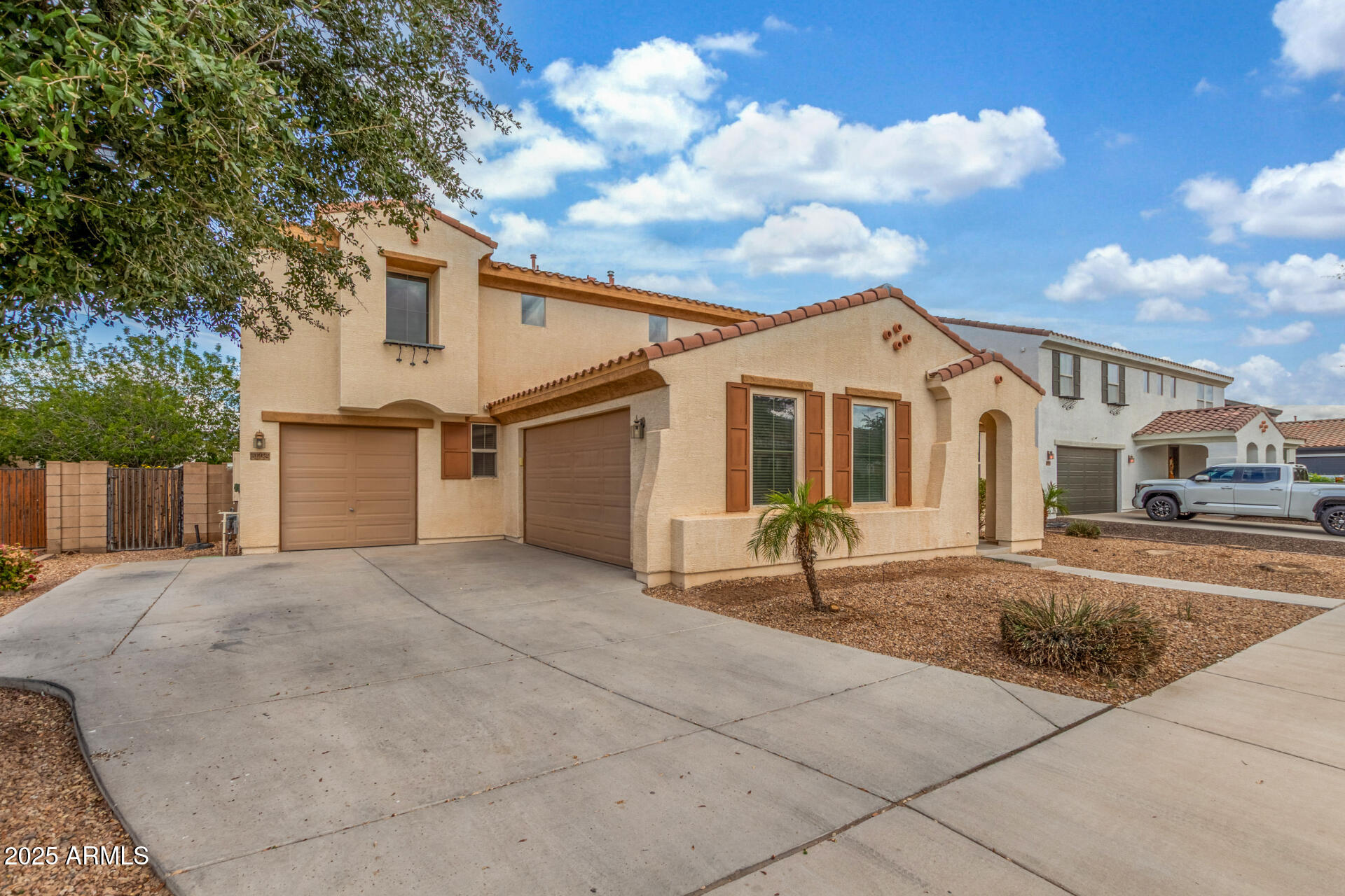 20932 Vía De Arboles Queen Creek, AZ 85142 - Photo 3 of 58 a front view of a house with a yard and garage