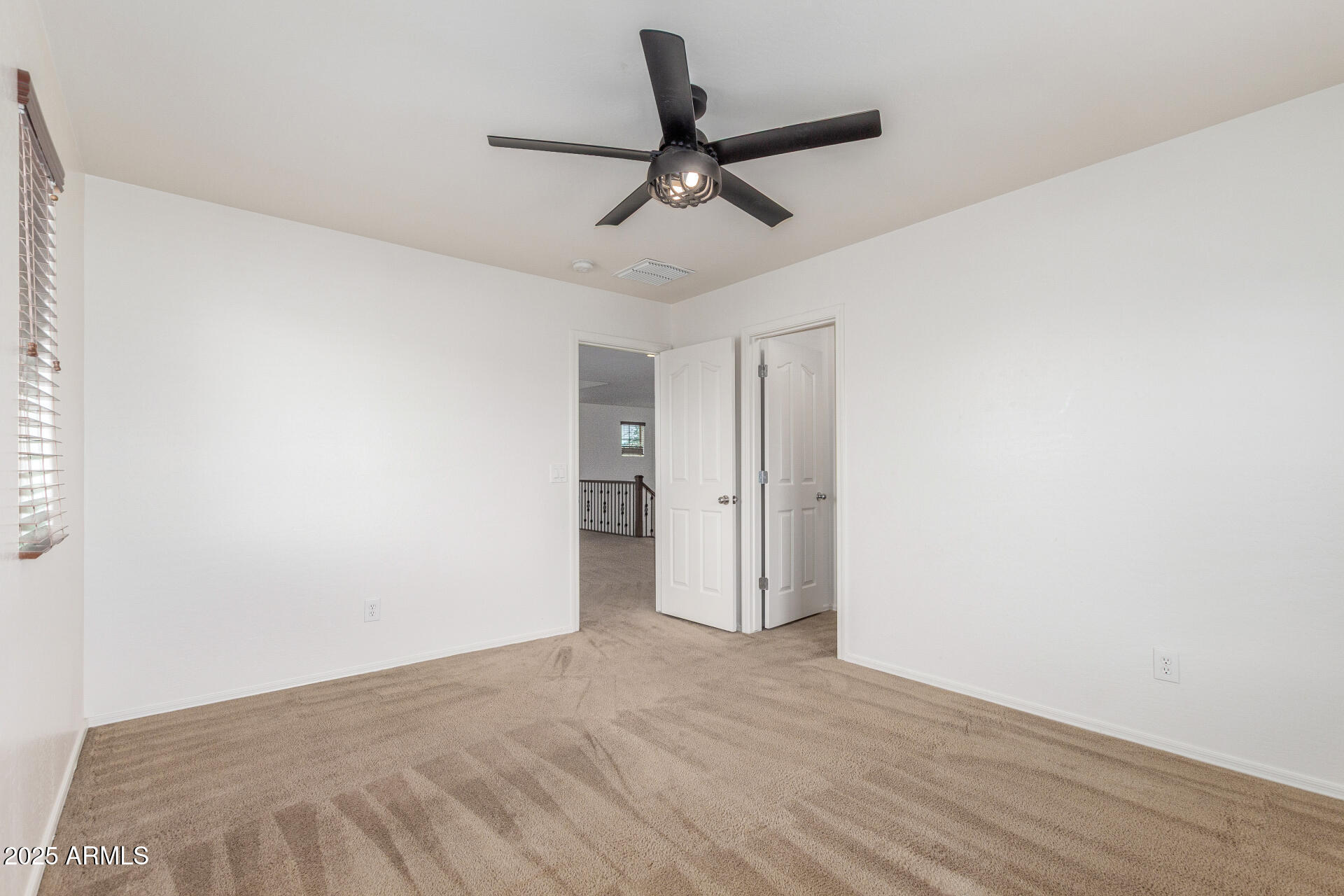 20932 Vía De Arboles Queen Creek, AZ 85142 - Photo 34 of 58 a view of a room with a ceiling fan and wooden floor