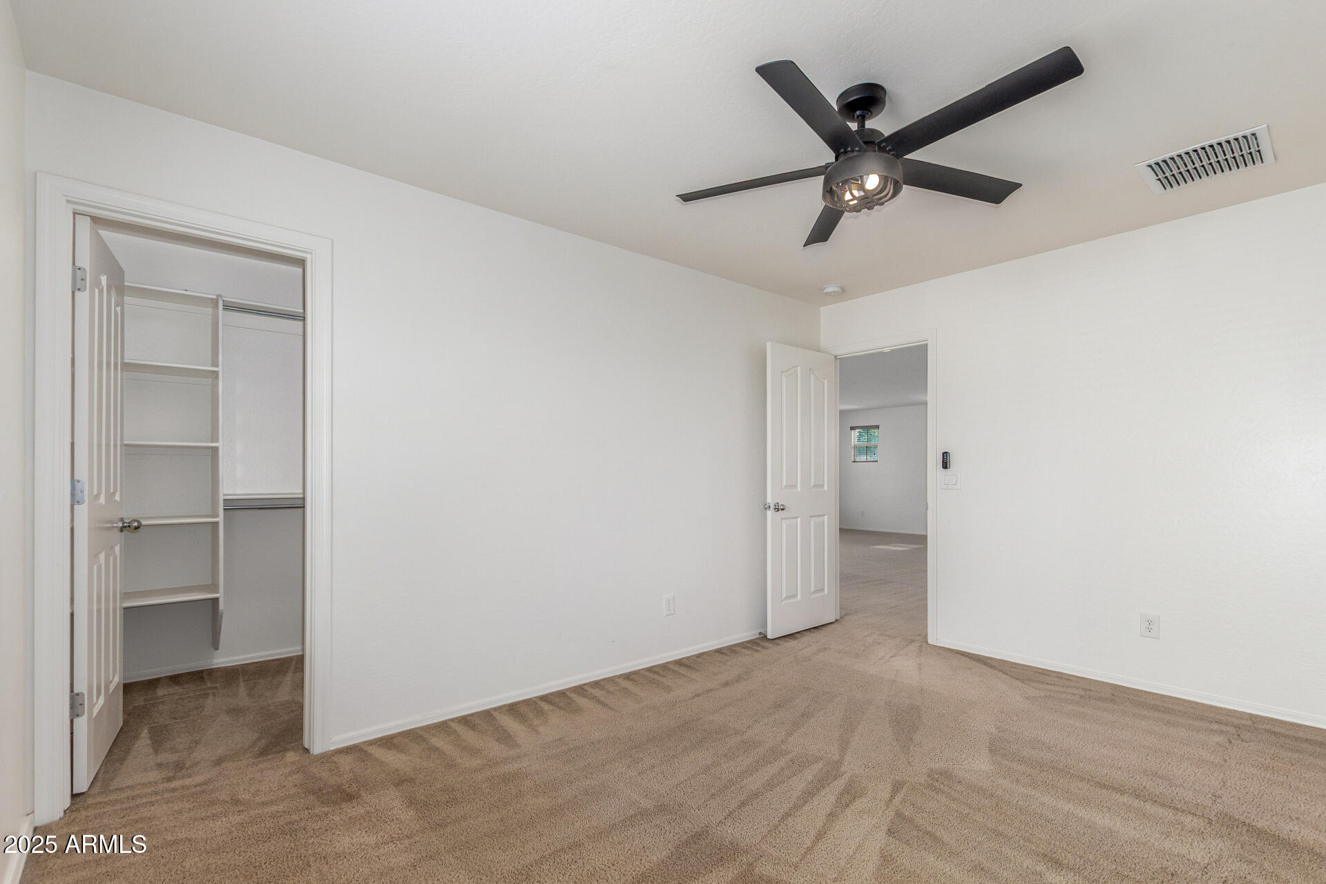 20932 Vía De Arboles Queen Creek, AZ 85142 - Photo 37 of 58 a view of a big room with wooden floor and a ceiling fan