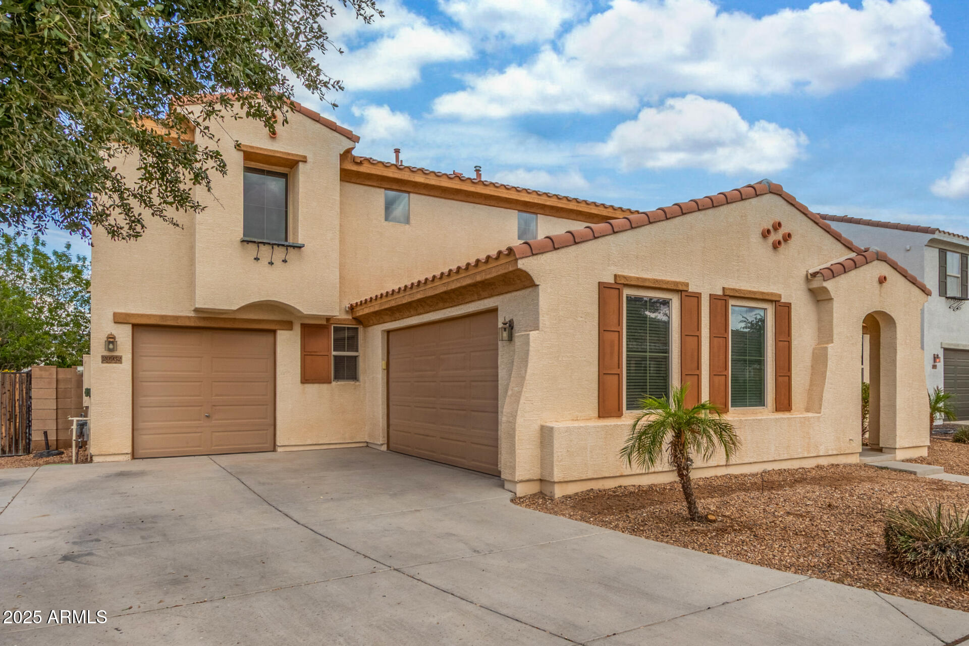 20932 Vía De Arboles Queen Creek, AZ 85142 - Photo 4 of 58 a front view of a house with a yard and garage