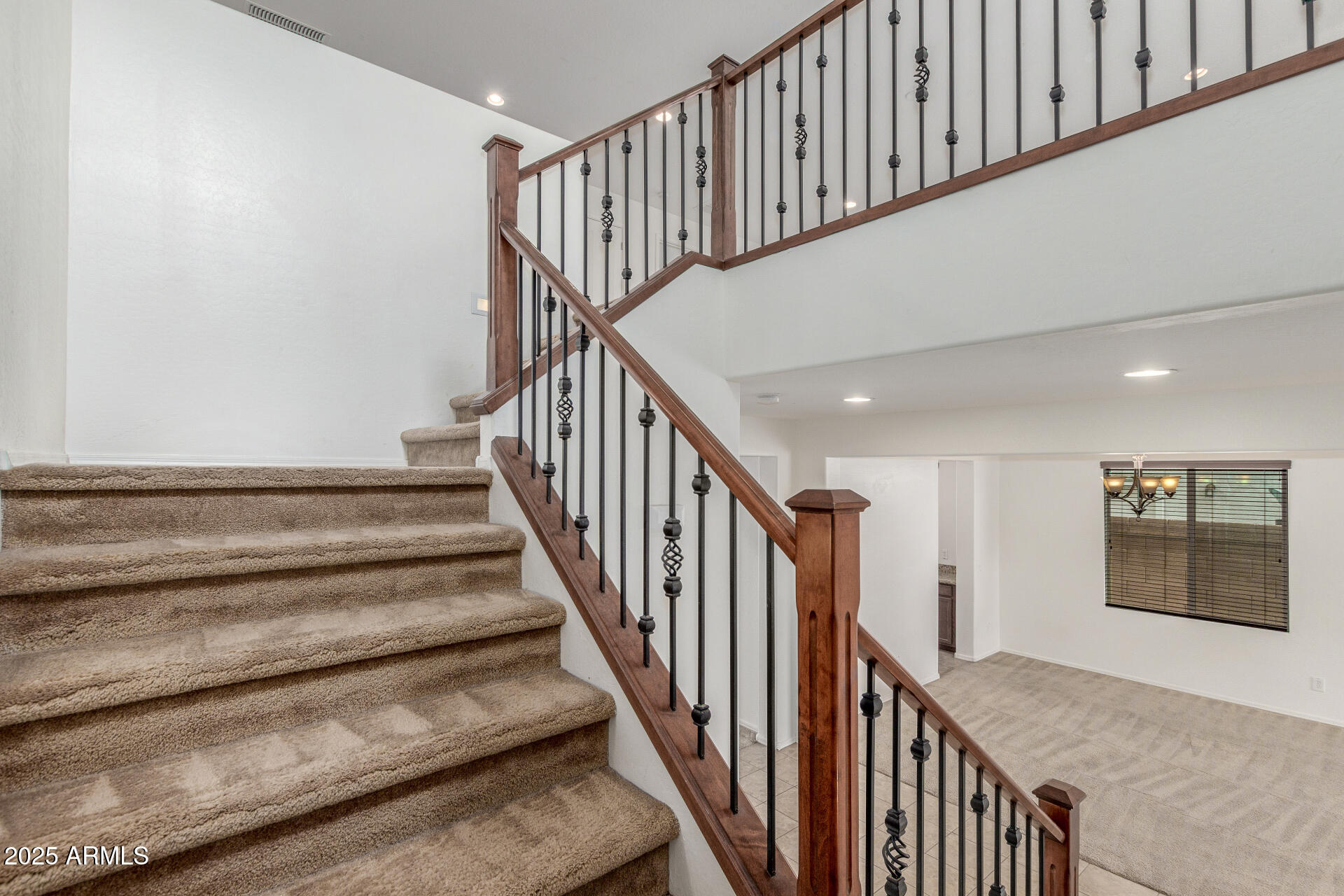 20932 Vía De Arboles Queen Creek, AZ 85142 - Photo 46 of 58 a view of staircase with lots of frames on wall and a window