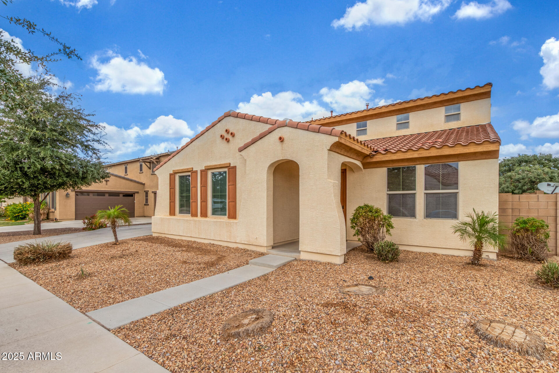 20932 Vía De Arboles Queen Creek, AZ 85142 - Photo 5 of 58 a front view of a house with garden