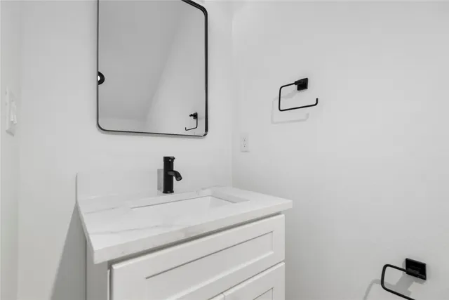 a bathroom with a sink and mirror
