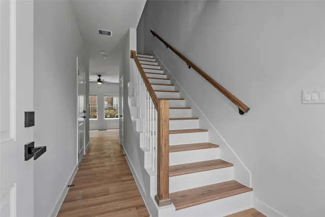 a view of a hallway with wooden floor and entryway