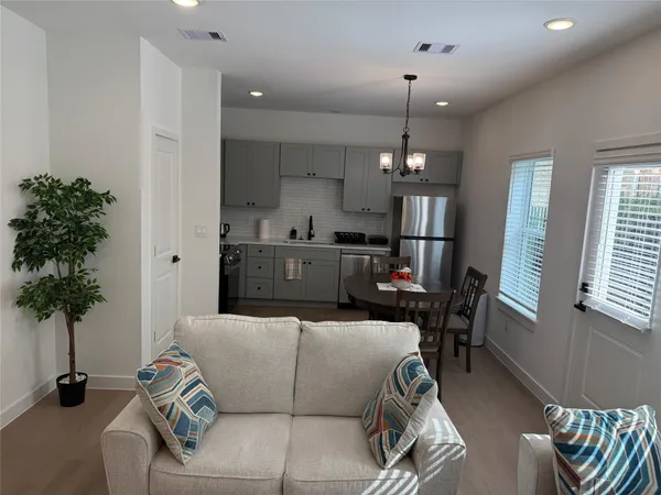 a living room with furniture and a chandelier