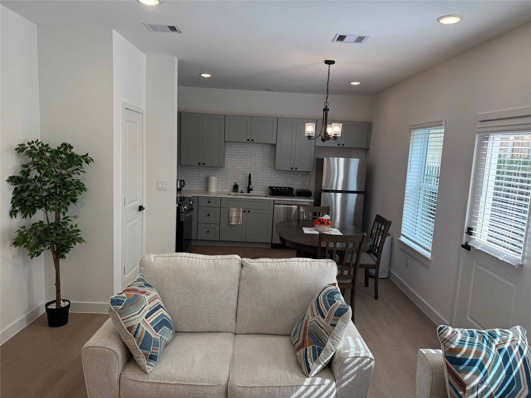 11621 Waldemar Drive Houston, TX 77077 - Photo 6 of 17 a living room with furniture and a chandelier