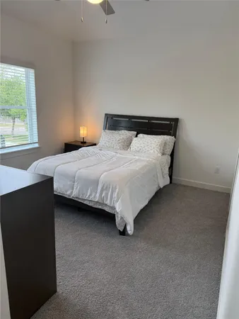 a bedroom with bed and window