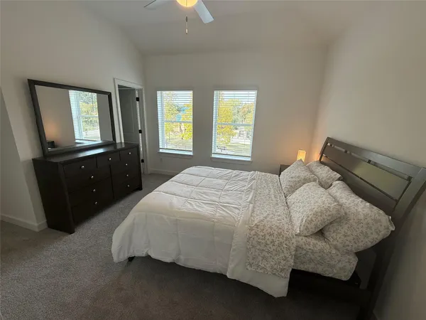 a bedroom with a bed and window