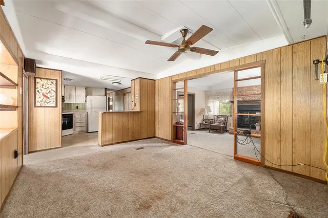 a view of an empty room with cabinet and a window