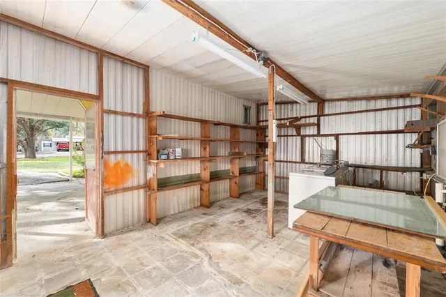 an aerial view of house with yard and green space