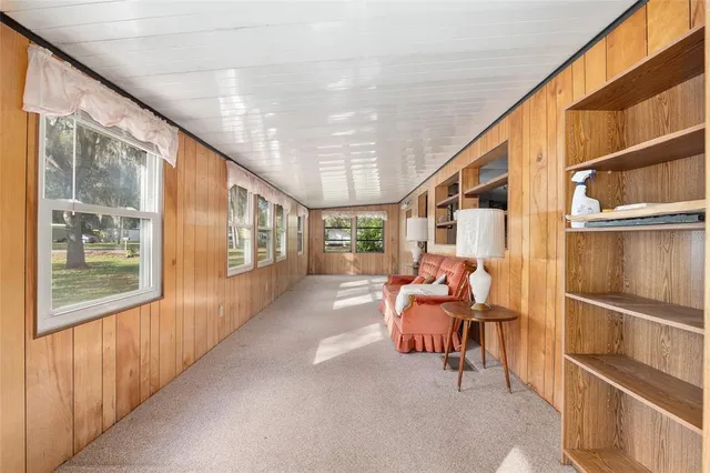 a view of a kitchen with microwave and refrigerator