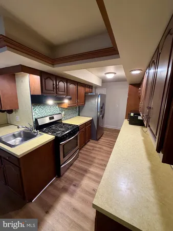 a kitchen with stainless steel appliances granite countertop a stove and a sink