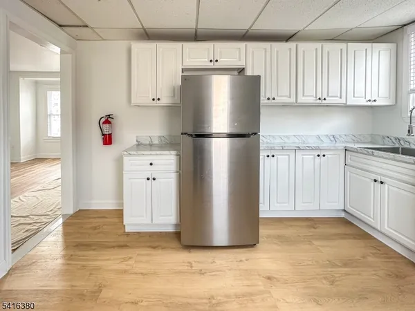 a kitchen with stainless steel appliances a refrigerator sink and cabinets