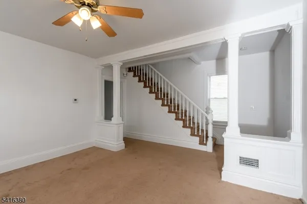 a view of entryway and hall with a front door