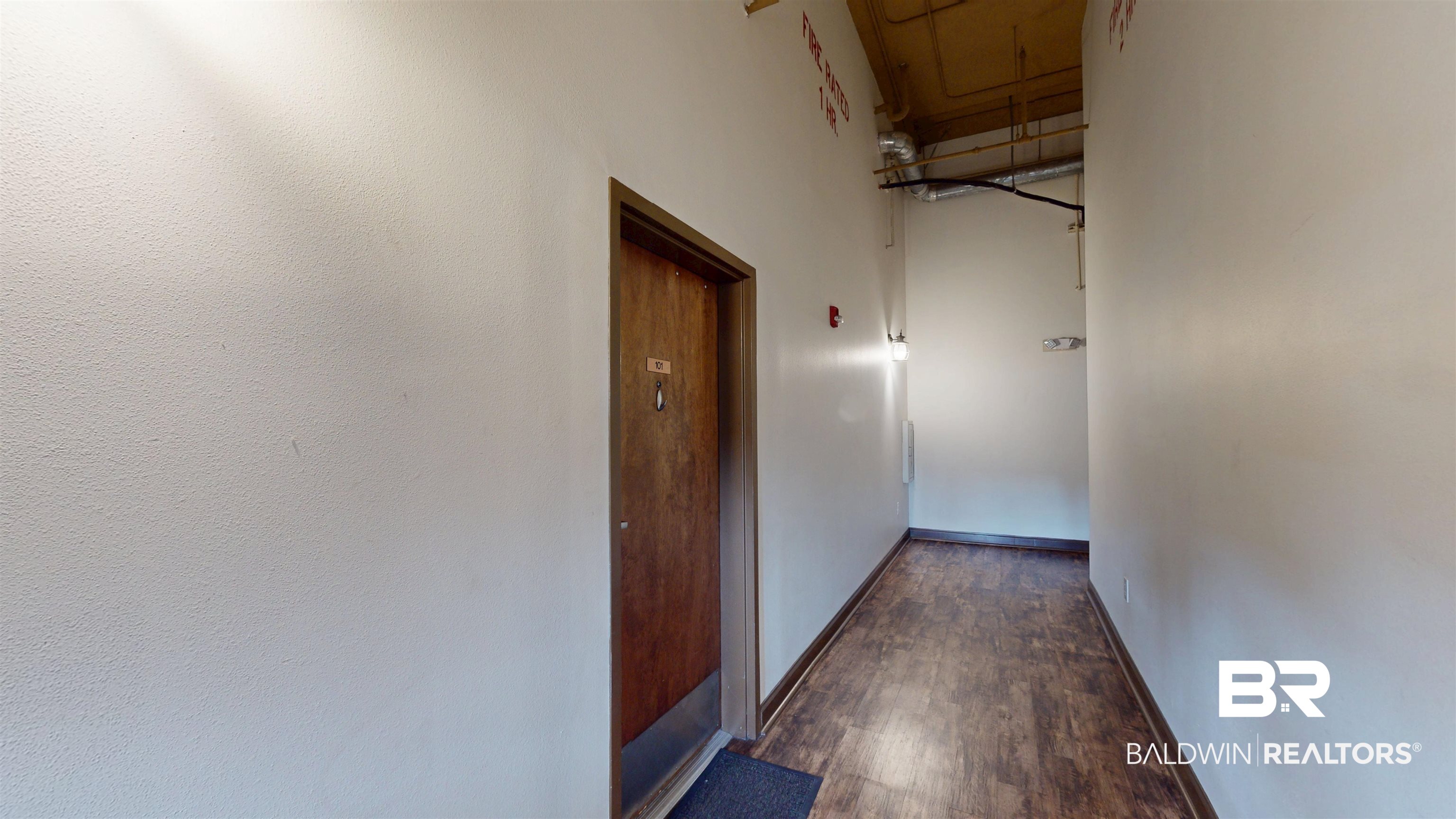 308 St Louis Street, Unit 101 Mobile, AL 36602 - Photo 9 of 30 Hallway featuring baseboards and dark wood-type flooring