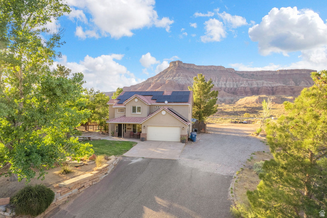 1440 West 100 South Virgin, UT 84779 - Photo 41 of 45 Two-story residence featuring a detached garage, a covered front porch, and solar panels