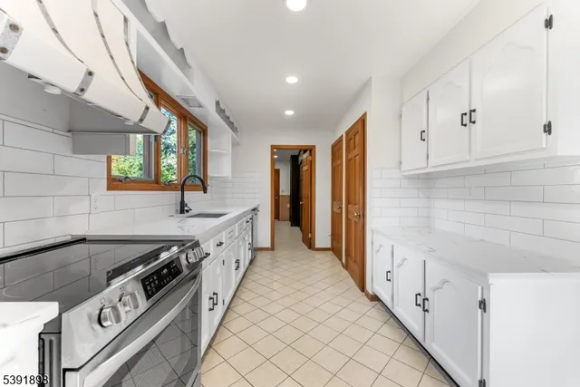 a kitchen with stainless steel appliances white cabinets and a stove