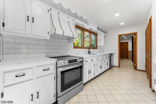 a kitchen with stainless steel appliances a refrigerator sink and cabinets