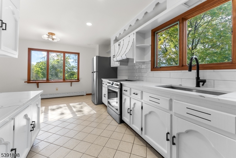 59 Cherryville Stanton Road Flemington, NJ 08822 - Photo 17 of 31 a kitchen with stainless steel appliances a sink stove and cabinets
