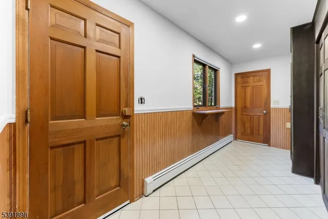 a room with walk in closet and wooden floor