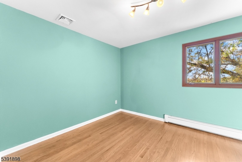59 Cherryville Stanton Road Flemington, NJ 08822 - Photo 23 of 31 a view of a big room with wooden floor and windows
