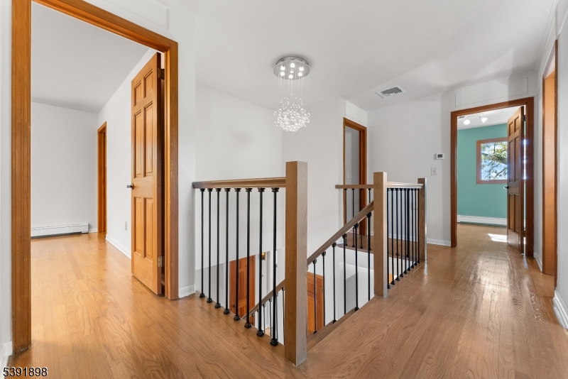 59 Cherryville Stanton Road Flemington, NJ 08822 - Photo 28 of 31 a view of a hallway with wooden floor and stairs