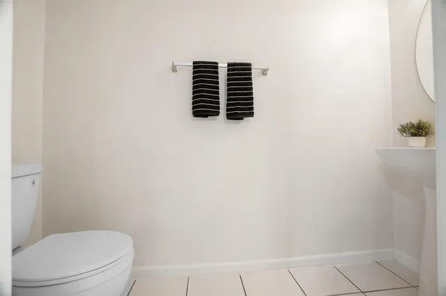 a bathroom with a toilet and a window