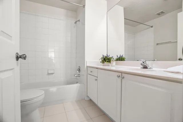 a bathroom with a double vanity sink toilet and shower