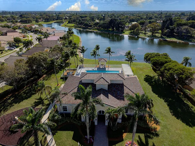 an aerial view of a house with a lake view