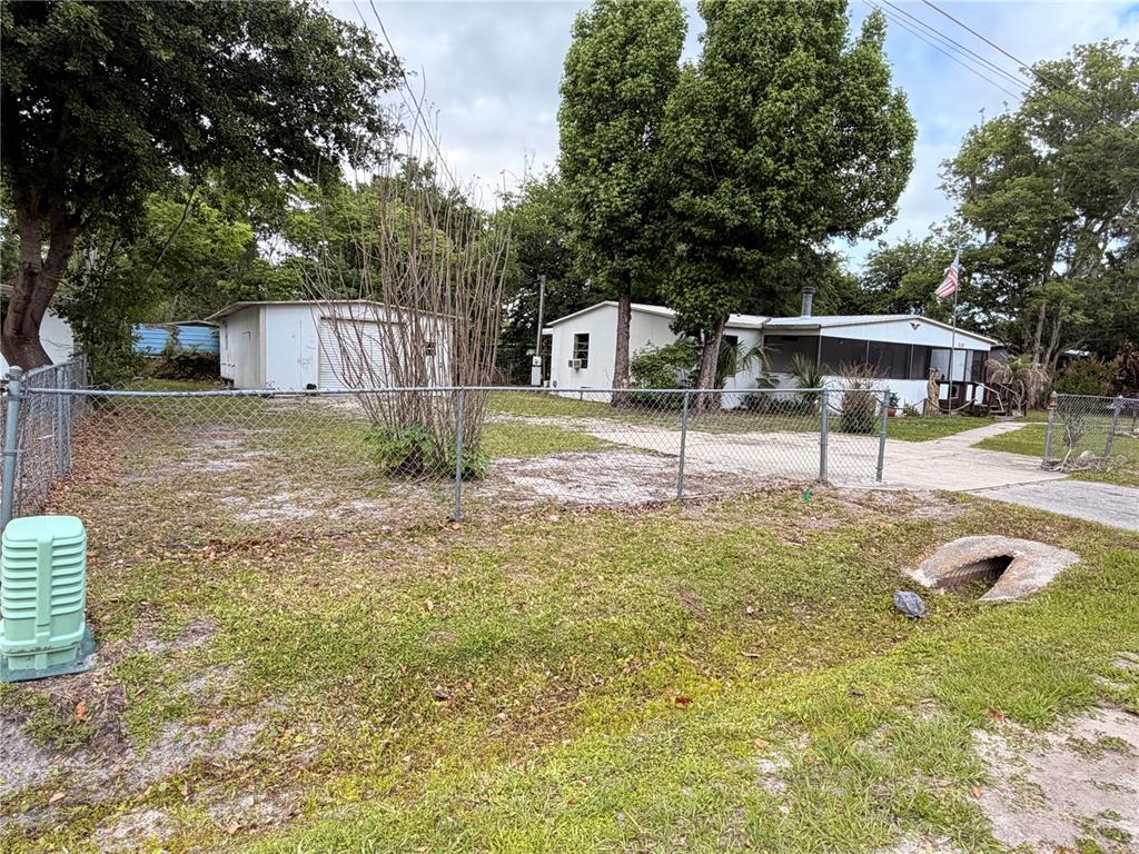 24021 Armadillo Road Astor, FL 32102 - Photo 1 of 38 a front view of a house with a yard and garage