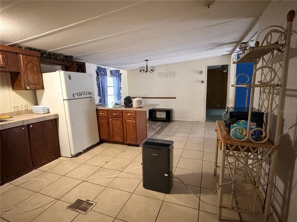 24021 Armadillo Road Astor, FL 32102 - Photo 14 of 38 a kitchen with refrigerator and washer