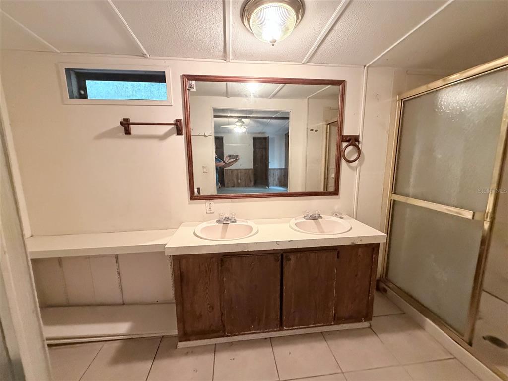 24021 Armadillo Road Astor, FL 32102 - Photo 18 of 38 a bathroom with a sink and a mirror