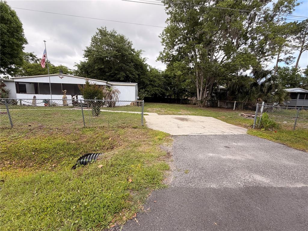 24021 Armadillo Road Astor, FL 32102 - Photo 27 of 38 a view of a house with pool and a yard