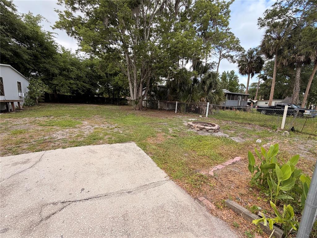 24021 Armadillo Road Astor, FL 32102 - Photo 28 of 38 a view of a swimming pool with a patio