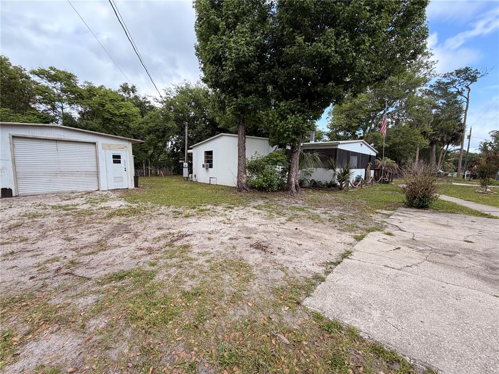 24021 Armadillo Road Astor, FL 32102 - Photo 30 of 38 a view of a house with a yard and large tree