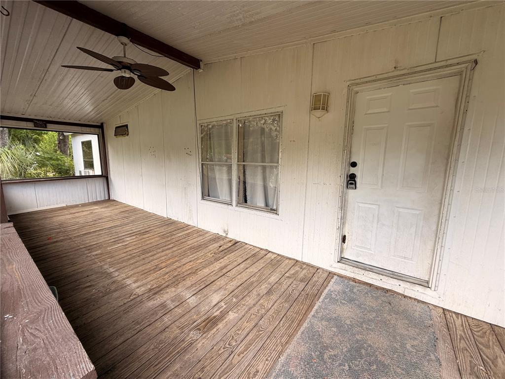 24021 Armadillo Road Astor, FL 32102 - Photo 3 of 38 en empty room with window and doors