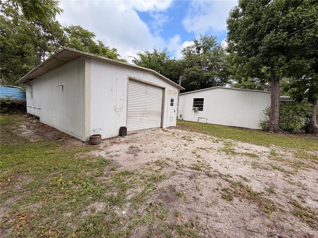24021 Armadillo Road Astor, FL 32102 - Photo 31 of 38 a view of a house with a yard and garage