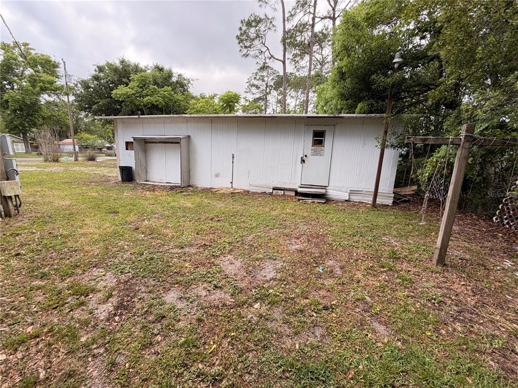 24021 Armadillo Road Astor, FL 32102 - Photo 36 of 38 a house that has a tree in front of it